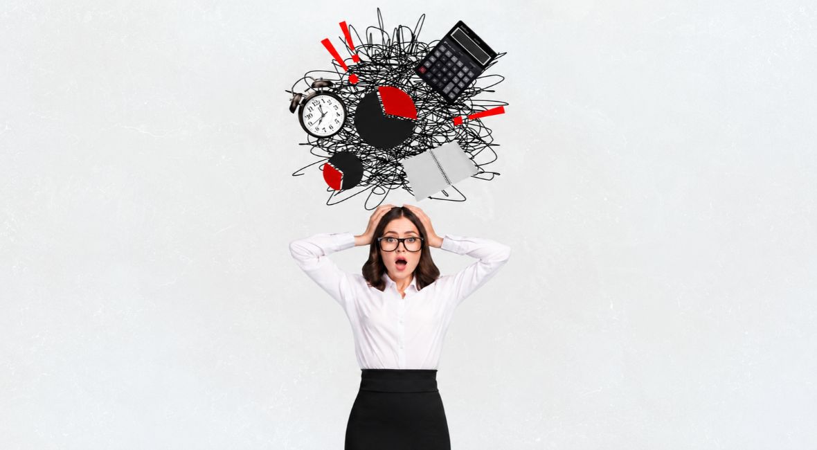 An overwhelmed woman holding her head beneath a tangle of scribbles, a clock, calculator, charts and red exclamation marks. Copy alt text